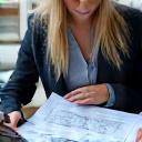 A person discussing blueprints with a client